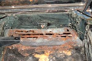 Rust hole in rear floor panel